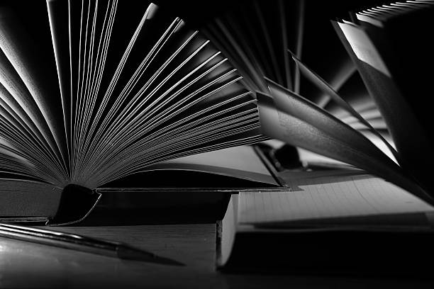 istock Open books, reading, learning, education or home office concept. Black and white image, free copy space. 2210621783