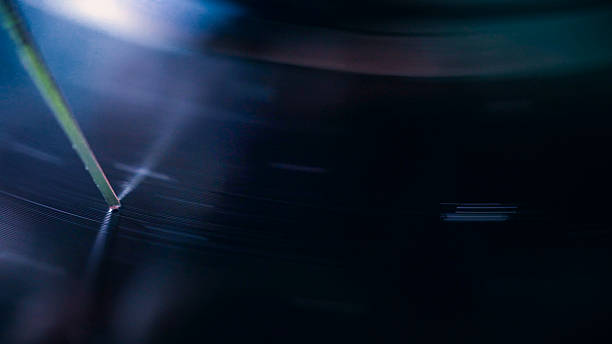 Close-up of a needle playing a scratched vinyl record, creating a nostalgic and evocative atmosphere