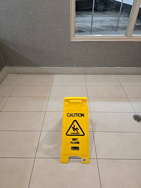 istock Yellow Caution Wet Floor Sign on Tiled Surface 2210622257