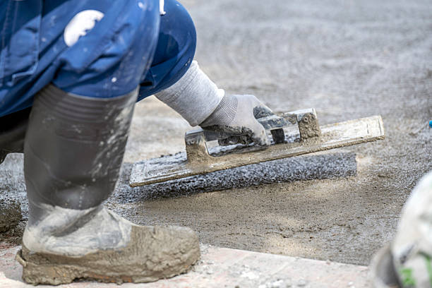 istock Construction work - man finishes concrete with trowel and plasterer 2210623264