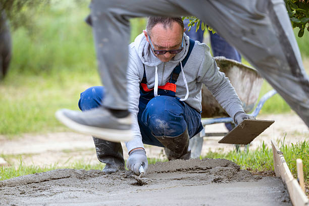 istock Construction work - man finishes concrete with trowel and plasterer 2210623307