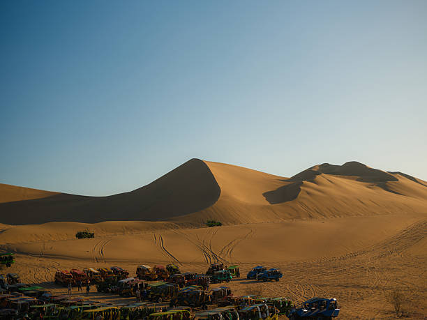 Offroad desert safari. SUV cars speeding in a sand dunes in Sahara desert