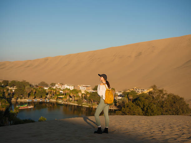 istock Woman exploring Huacachina oasis during trip to Peru 2210630509