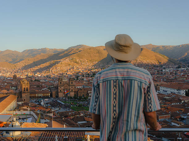 istock Man looking at Cusco cityscape at sunset from viewpoint 2210630852