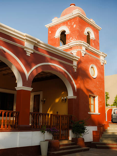 Scenic bell tower in colonial style in Huacachina oasis in Peru