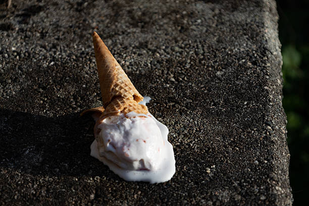 istock ice cream cone crashing on the floor dripping with melted ice cream 2210636875