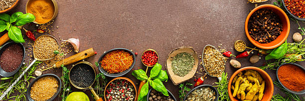 istock A visually striking arrangement of fresh spices and herbs on a brown surface, highlighting their vivid colors, intricate details, and rich culinary essence, banner 2210642886