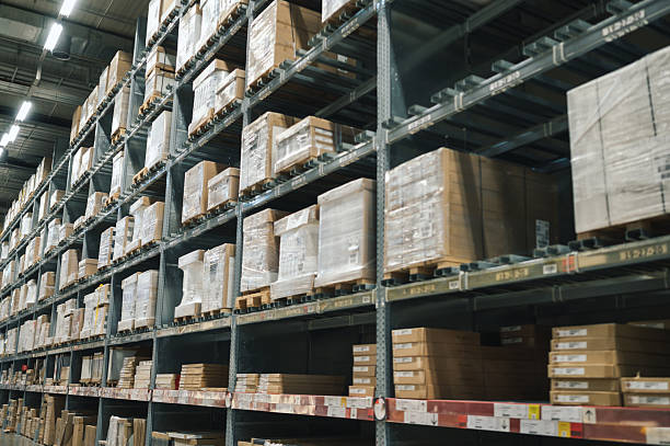 istock Lage retail warehouse saller Empty warehouse, view down the asile with shelves and boxes. 2210644757