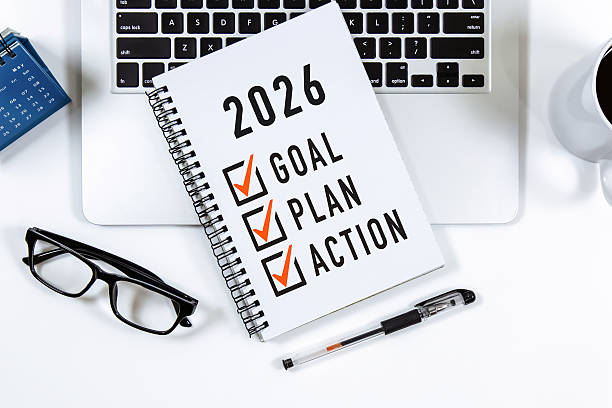 istock 2026 Goal, Plan, Action checklist text on note pad with laptop, glasses and pen. 2210646639