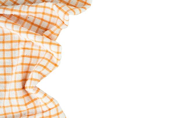 Tablecloth with orange and white stripes which when crossed form squares as a background, texture, pattern.