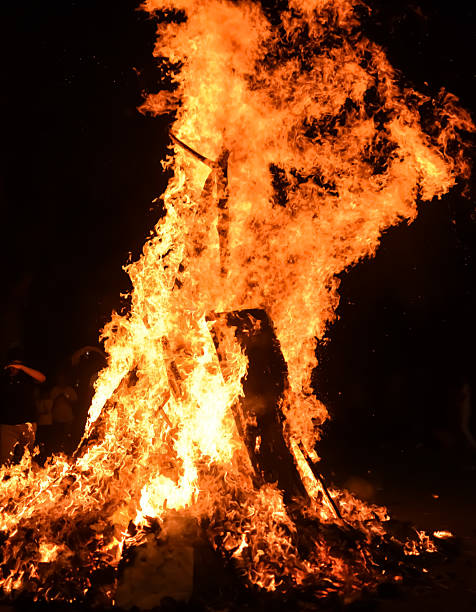 istock Fire flames on black background, Blaze fire flame texture background, Beautifully, the fire is burning, Fire flames with wood and cow dung bonfire 2210653037