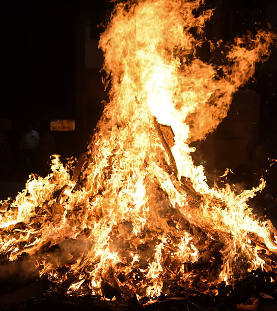 istock Fire flames on black background, Blaze fire flame texture background, Beautifully, the fire is burning, Fire flames with wood and cow dung bonfire 2210653041