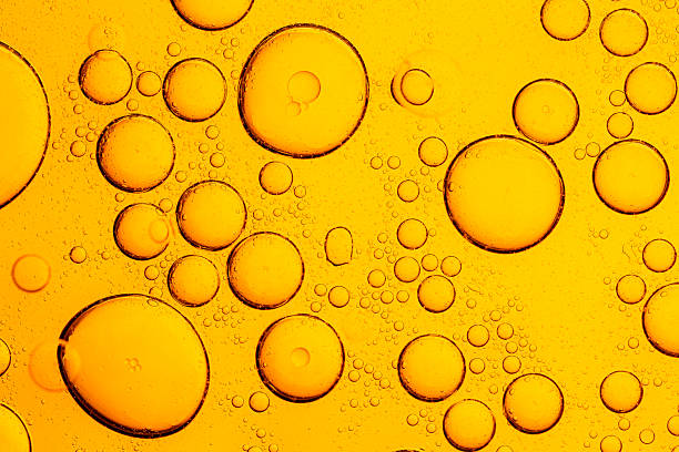 istock Macro lemon bubble texture,Fresh lemon slice in water with bubbles on white background,Lemon texture, macro. Abstract yellow summer background. 2210653562