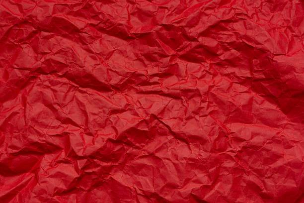 istock Red crumpled paper texture macro,Red crumpled paper as a texture or background. Bright red crumpled paper for backgrounds, design, packaging, holiday cards or creative projects, for valentines, and visual compositions. 2210653664