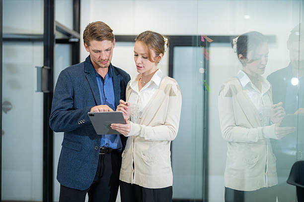 istock Colleagues discussing project details in a modern office environment during a business meeting 2210654062