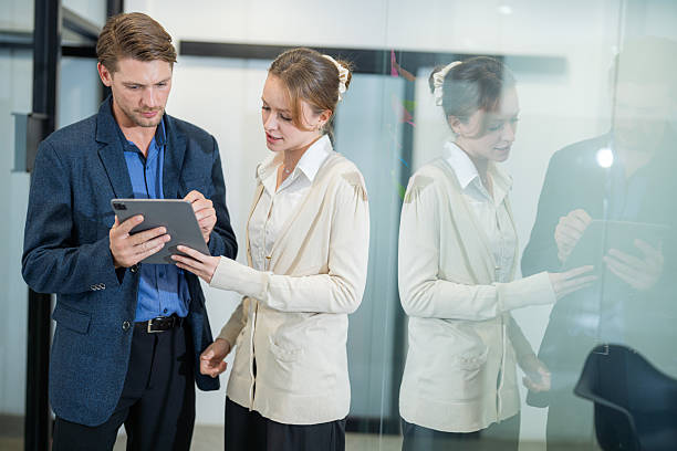 istock Business professionals discussing project details in a modern office environment during day hours 2210654067