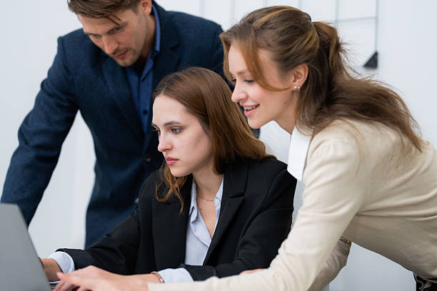 istock Collaboration among three business professionals in a modern office setting during a team meeting in the afternoon 2210657460