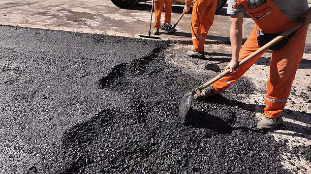 istock Construction workers working on a new asphalt layer on a public street. 2210659361