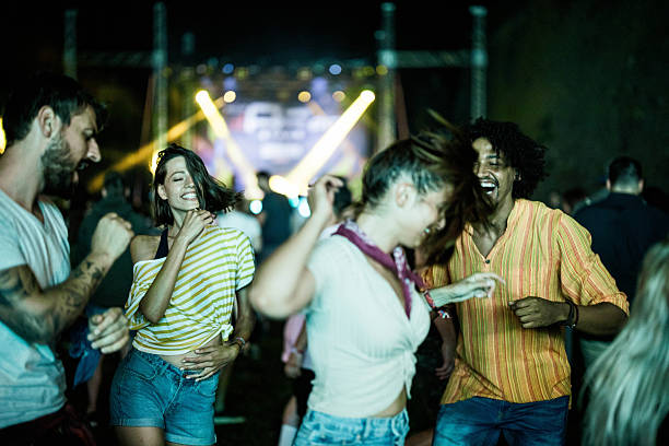 istock Happy couples having fun while dancing on music concert. 2210660644