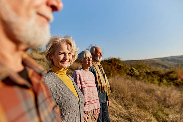 istock Happy mature friends looking at view from a hill. 2210661606