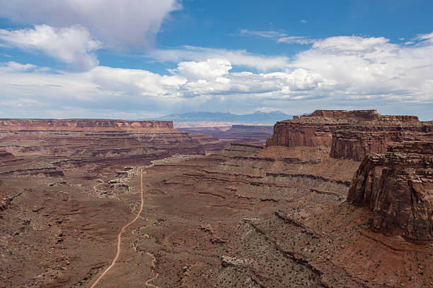 istock Expansive view of desert landscape with dramatic rock formations in a remote area under a bright sky 2210661726