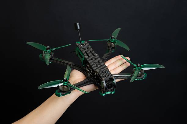 istock Professional modern drone with digital camera in hand on black background 2210662538