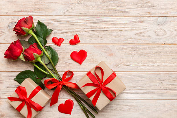 istock Valentine's day composition with rose flower, red heart and gift boxes on table. mother day and birthday greeting, copy space, top view 2210665308