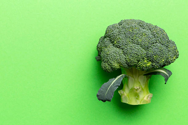 istock Top view fresh green broccoli vegetable on Colored background. Broccoli cabbage head Healthy or vegetarian food concept. Flat lay. Copy space 2210665344