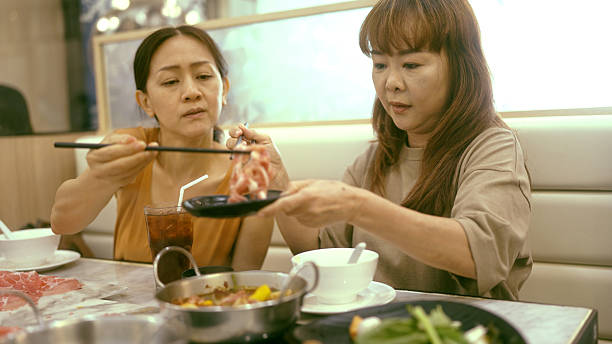 istock Siblings eating Shabu Shabu together 2210665361