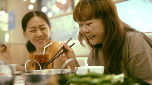 istock Siblings eating Shabu Shabu together 2210665373