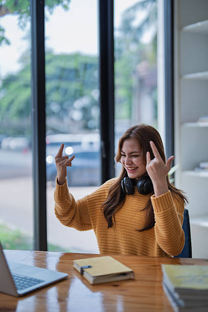 istock young woman happy, viewing her excellent success score in her e-learning program displayed on her laptop at her desk at home 2210665586