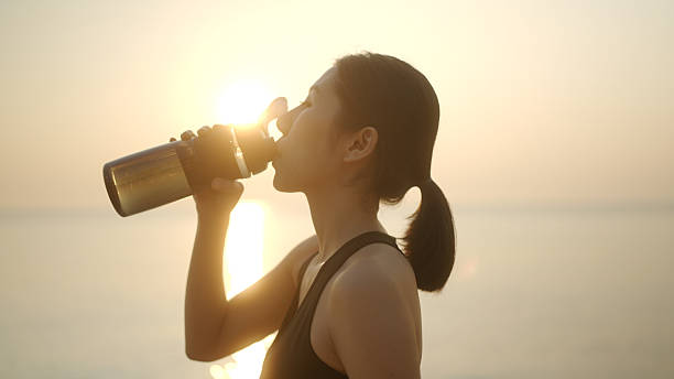 istock Asian athlete woman drinks water after running 2210666071