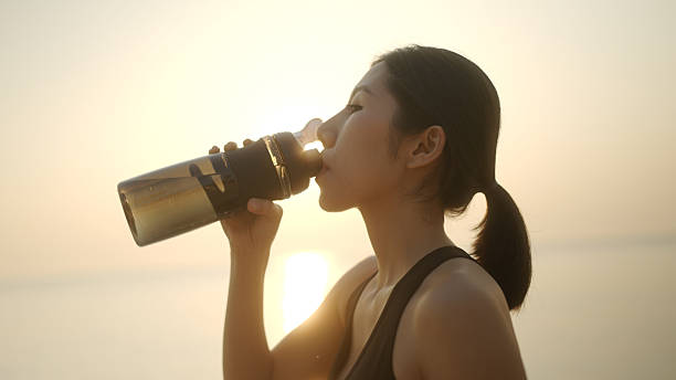 istock Asian athlete woman drinks water after running 2210666091