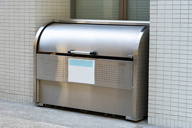 istock Large metal garbage box installed outside a condominium 2210667282