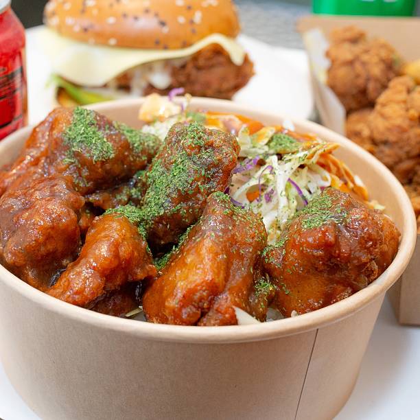 istock Korean deep-fried chicken on white rice with hot spicy sauce 2210667350