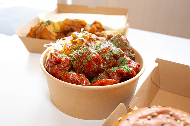 istock Korean deep-fried chicken on white rice with hot spicy sauce 2210667415