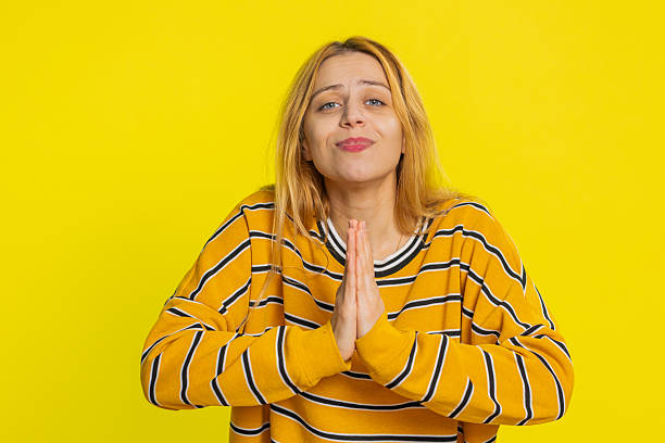 istock Middle-aged woman praying making wish, asking hopeful help, begging apology, meditation, imploring 2210667817