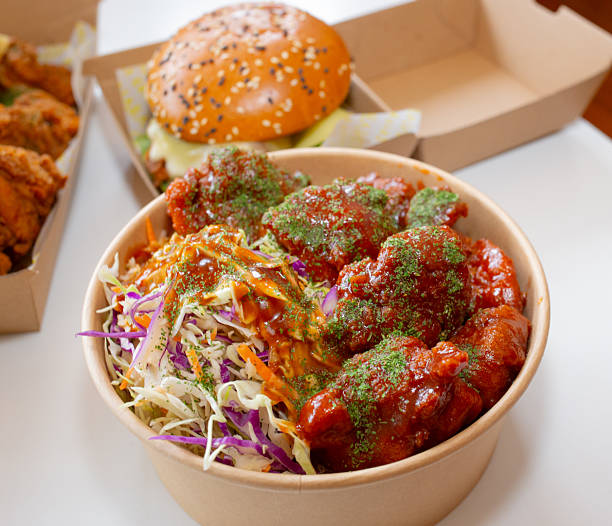 istock Korean deep-fried chicken on white rice with hot spicy sauce 2210667885