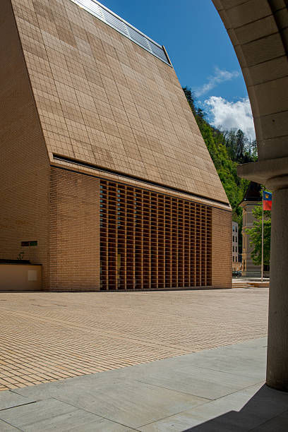 Modern architecture of the Landtag building in Vaduz, Liechtenstein, with geometric design and blue sky.