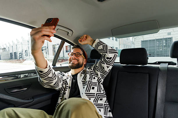 istock Man Having Video Call in Car Backseat 2210668219