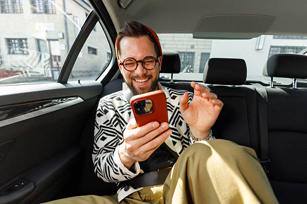 istock Man Having Video Call in Car Backseat 2210668229