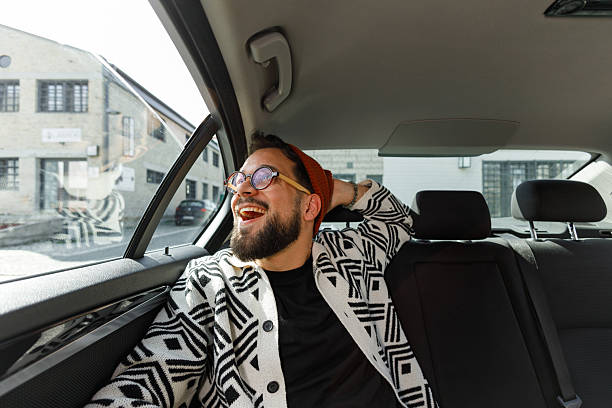 istock Cheerful Man Relaxing in Car Backseat 2210668230