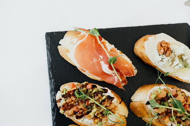 istock Tasty appetizers featuring various toppings on toasted bread slices 2210669312