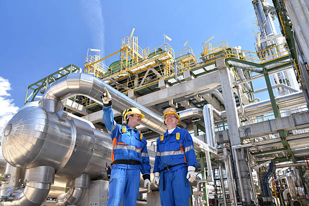 istock group of workers professional equipment in a petroleum refinery - modern buildings and industrial facilities for the production of fuel and gas 2210669727