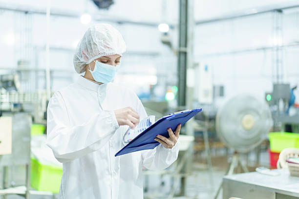 istock Quality control officer is randomly inspecting a raw materials in canned fish production facility. 2210674431