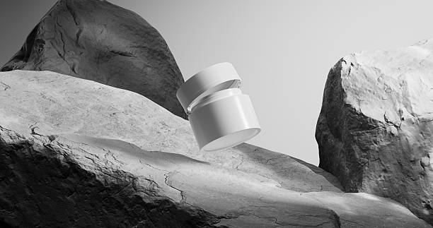 istock A white cosmetic jar floats above rugged stone textures in a minimalist grayscale setting. 2210674617