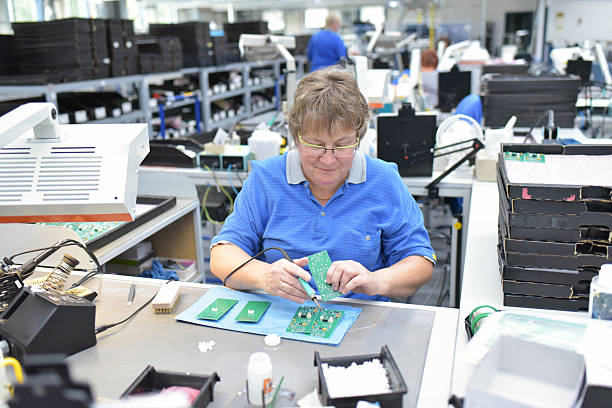 istock friendly woman working in a microelectronics manufacturing factory - component assembly and soldering 2210676533