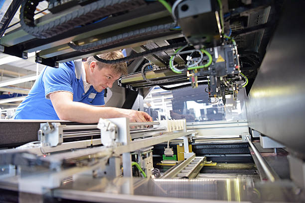 istock engineer working on a machine for assembly and production of semiconductor boards in an industrial plant 2210676768