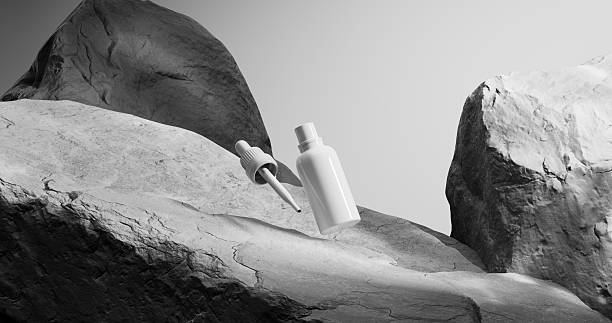 istock A white cosmetic bottle and its dropper float above a rocky landscape. 2210677429