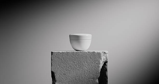 istock A cylindrical jar sits atop a rugged stone pedestal under soft lighting. 2210677446